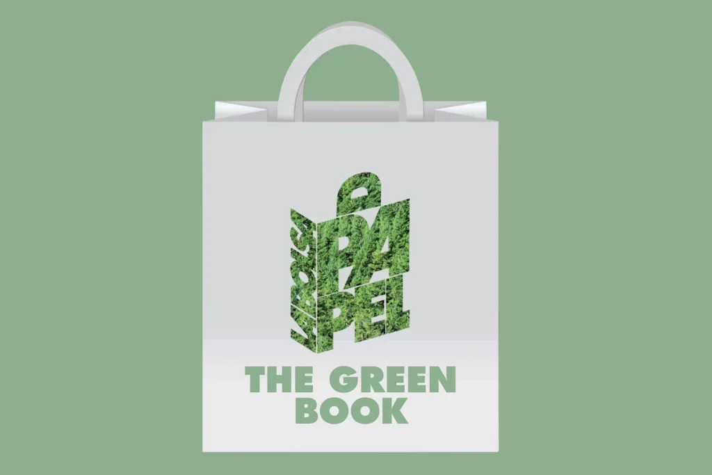 White paper bag with flat handles on a green background, featuring The Paper Bag logo in stacked letters filled with a forest texture and, below, the text 'The Green Book'.